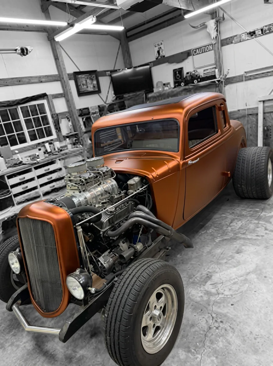 Copper metallic wrap on a hot rod pickup inside the RAD Wrapz Garage shop